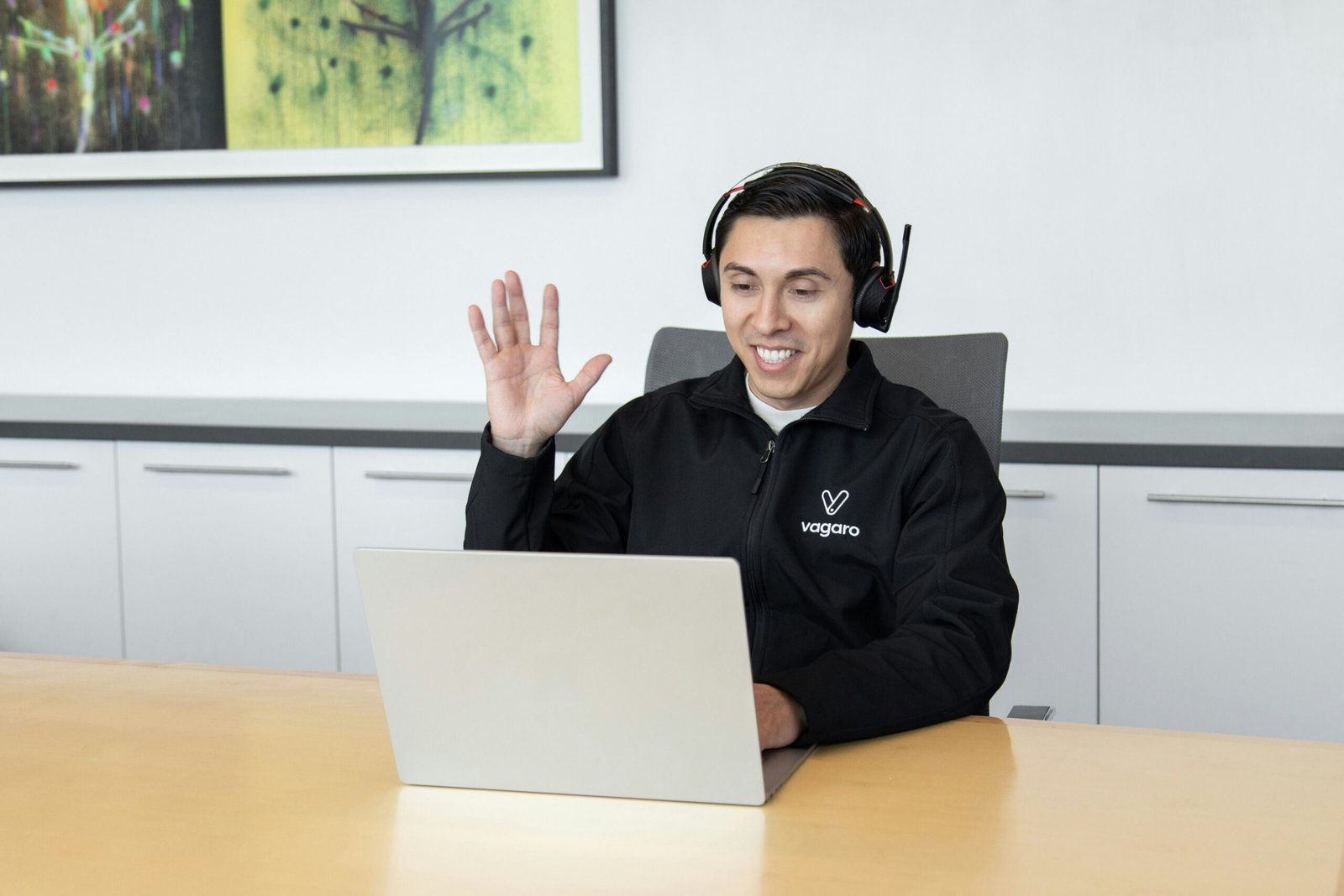 a man wearing headphones sitting in front of a laptop computer